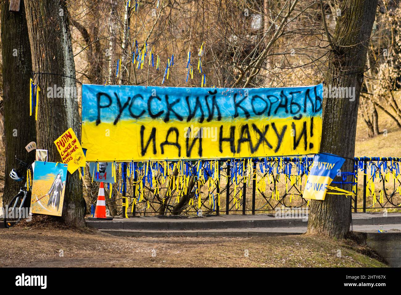 Preparing a peaceful demonstration against war in support of Ukraine with placards, flags, Cyrillic letters. Stop War Stock Photo