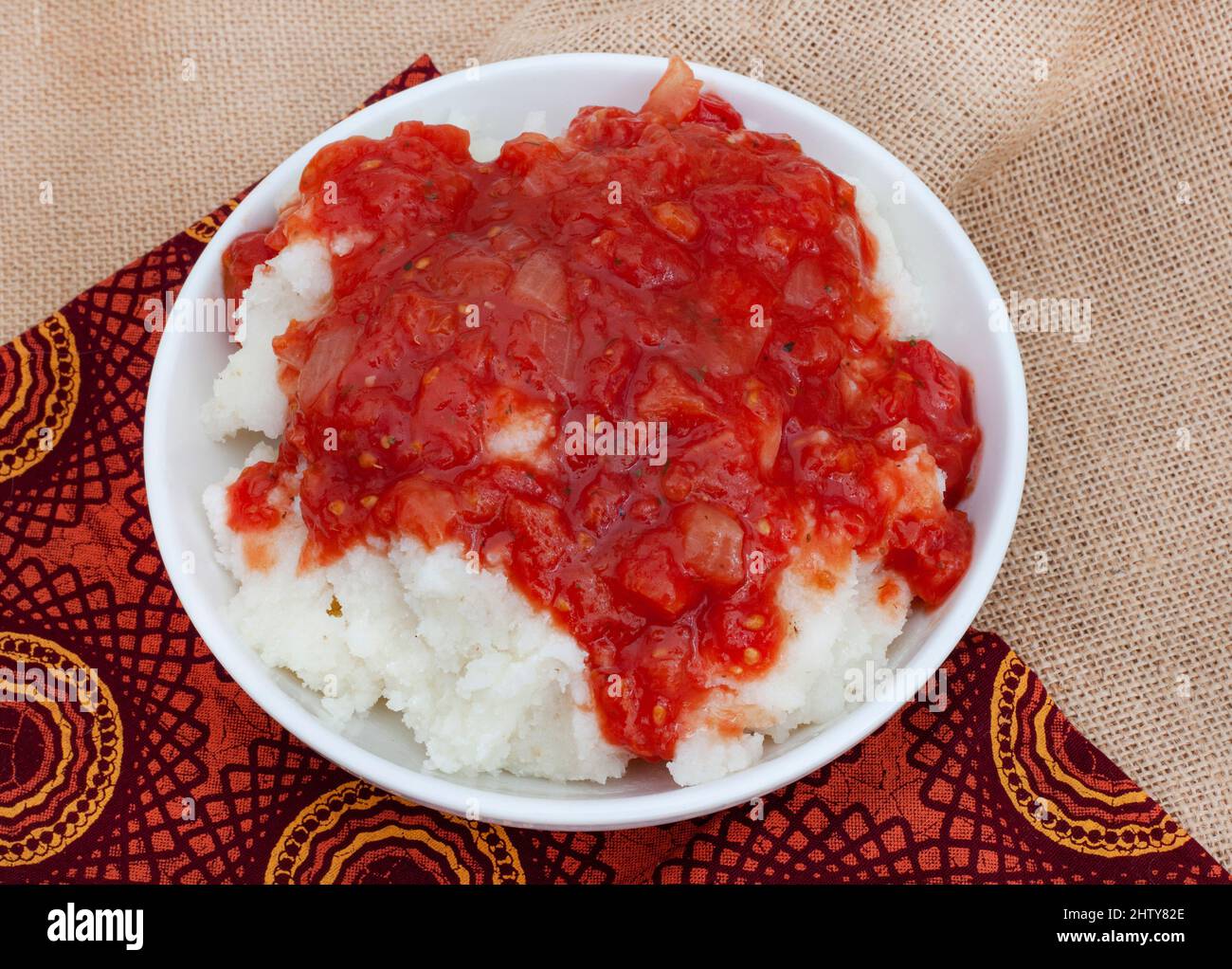 Traditional South African Pap and sous, maize meal covered in tomato and onion relish Stock Photo