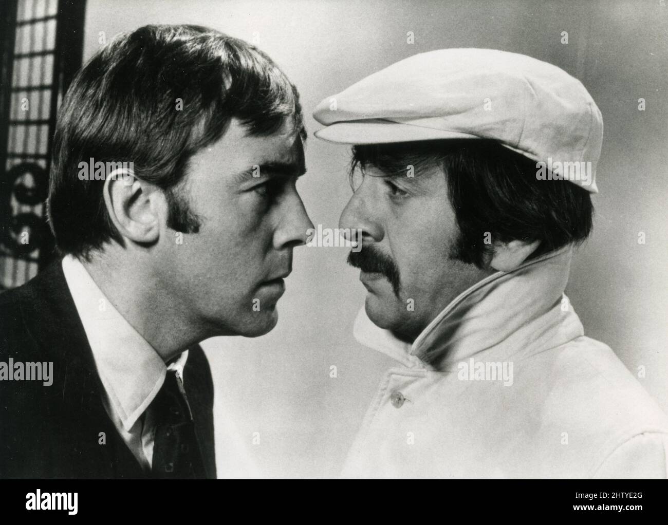 Actors Haym Topol and Michael Jayston (left) in the movie Follow Me!, UK 1972 Stock Photo