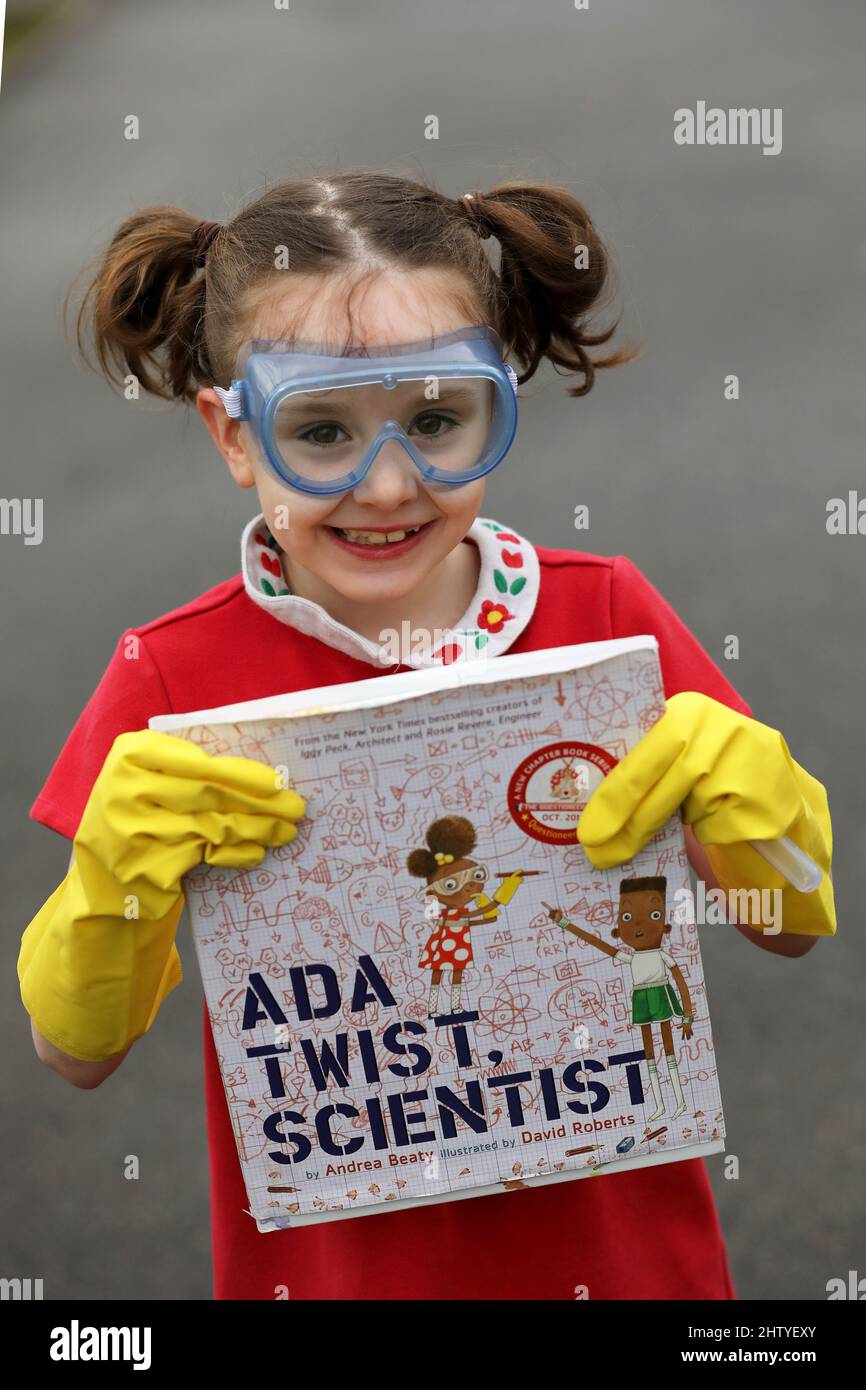 Chichester, West Sussex, UK. 03rd Mar, 2022. Florence, 6, dressed in red as Ada Twist Scientist, a book by Andrea Beaty and illustrated by David Roberts. She is on her way to school dressed up and having fun on World Book Day. Credit: Sam Stephenson/Alamy Live News Stock Photo