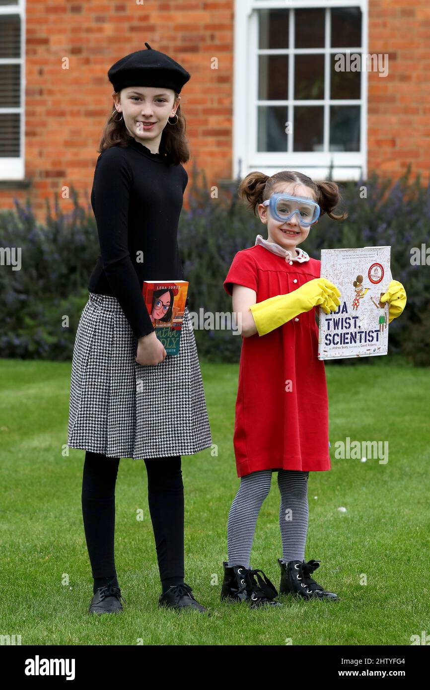 Chichester, West Sussex, UK. 03rd Mar, 2022. Florence, 6, dressed in red as Ada Twist Scientist, a book by Andrea Beaty and illustrated by David Roberts, and her sister Isabelle, 10, dressed in black as Agatha Oddlyon, a character in a book by Lena Jones. Both on their way to school dressed up and having fun on World Book Day. Credit: Sam Stephenson/Alamy Live News Stock Photo
