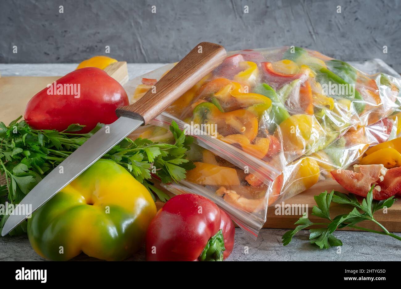 Sliced ripe bell pepper fruits in cellophane bags, prepared for