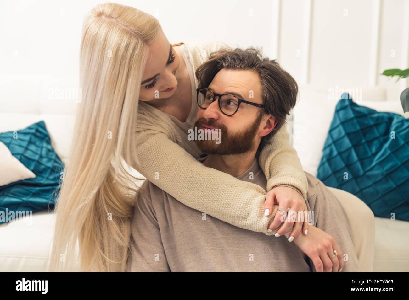 adorable millennial couple cuddling and looking each other in the eye, trustful and happy relationship concept. High quality photo Stock Photo