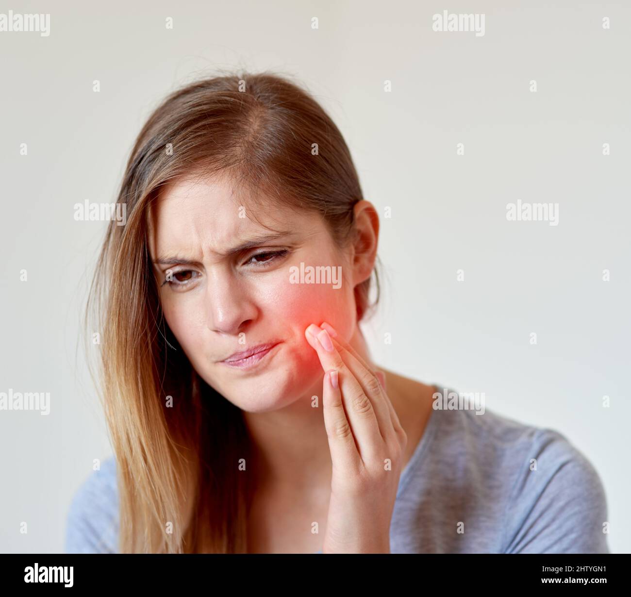 Toothache Red That looks like it hurts. Cropped shot of a young woman experiencing a ...