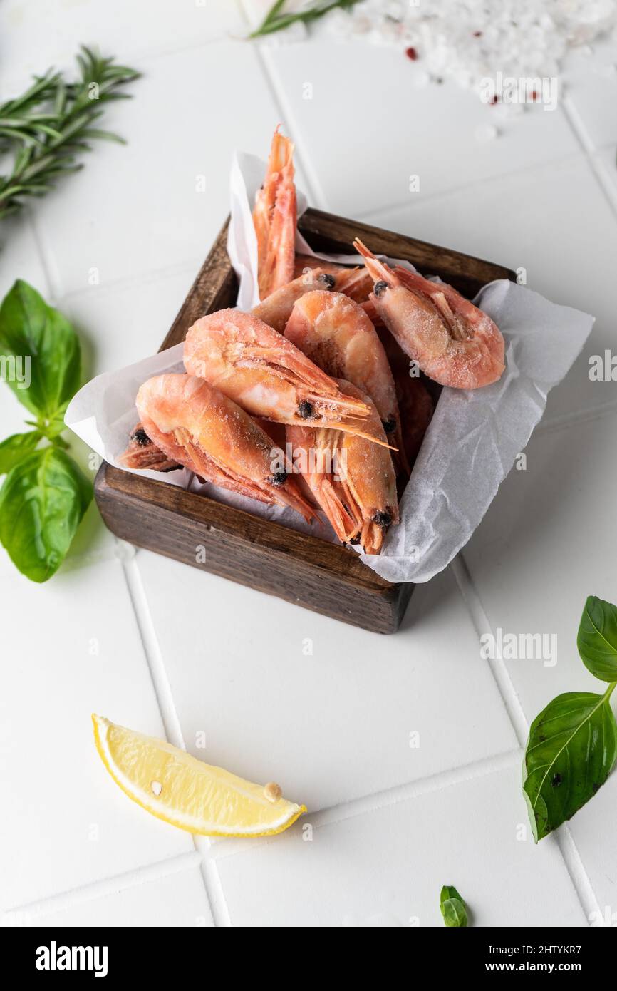 Thawed peeled shrimp, seafood, delicacy. on a white background, in a ...