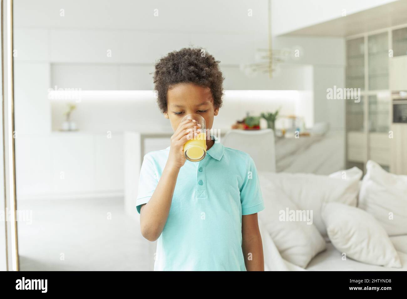 Kid boy drinking orange juice at home Stock Photo Alamy