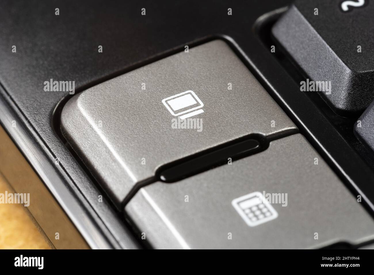 Computer monitor symbol shortcut macro activation key, button on a modern office keyboard, object detail, extreme closeup. Desktop PC icon, hardware, Stock Photo