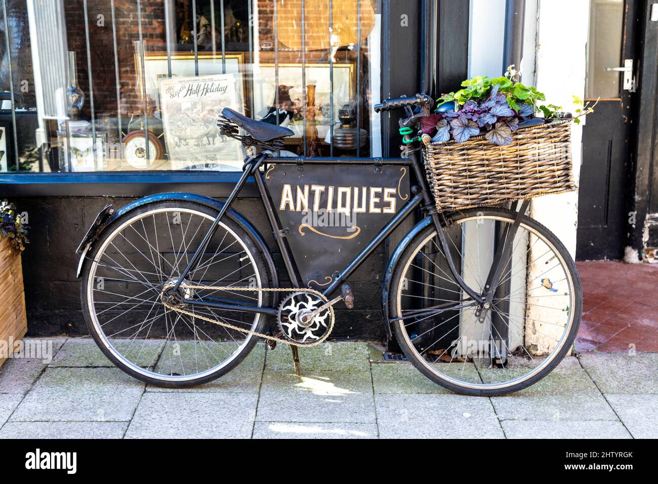A decorative bicycle outside Blackfriars Antiques shop on Tower Street, King's Lynn, England, UK Stock Photo