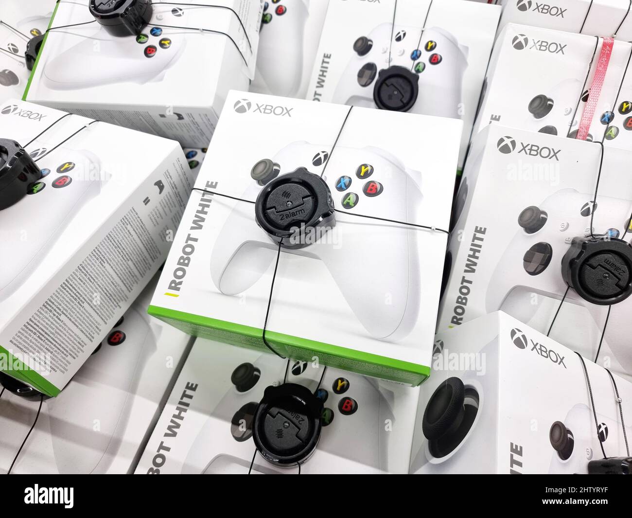 Microsoft Xbox One white controller, game pad packages, multiple packaged video game console controllers, store display, group of objects, closeup, no Stock Photo