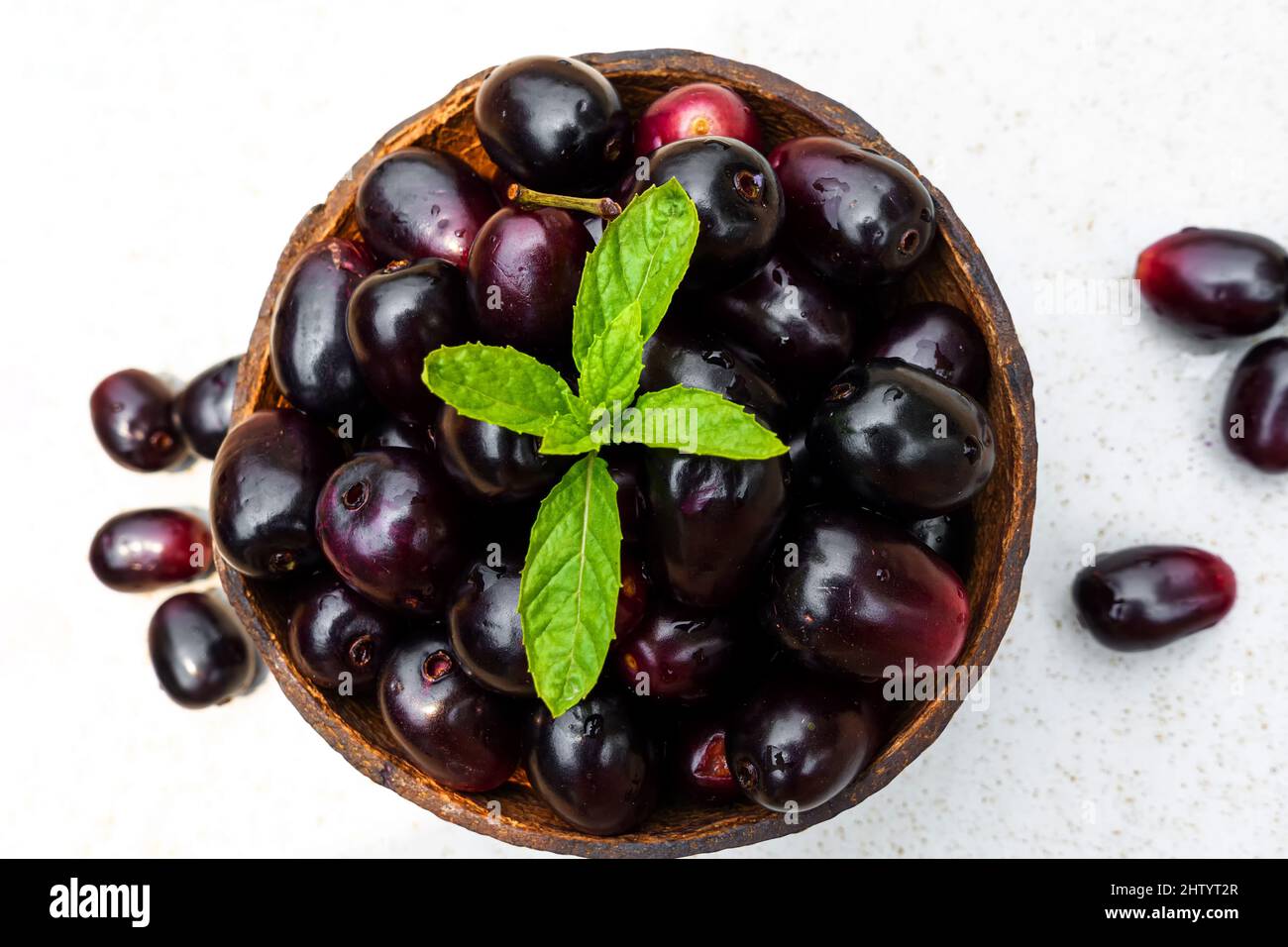 Dark pink-red ripe Syzygium cumini fruits. Dark black java plum in a ...