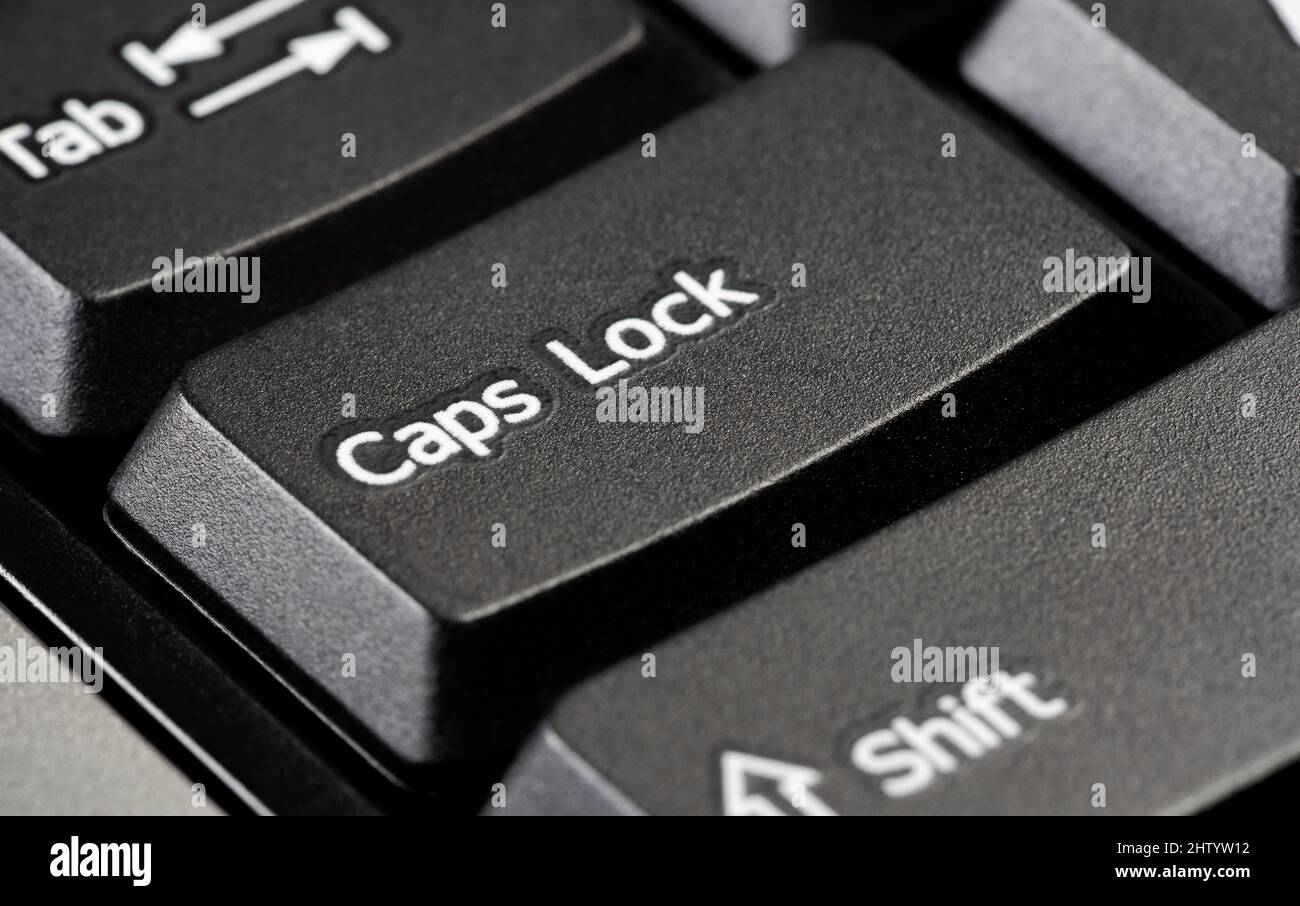 Single caps lock key on a simple black desktop PC computer keyboard, object  detail, extreme closeup. Using capital letters, typing in all caps, scream  Stock Photo - Alamy