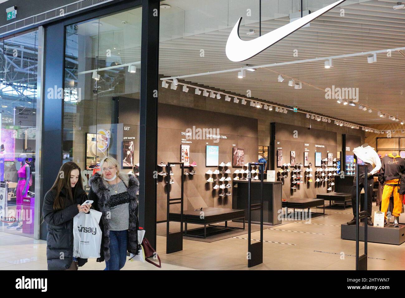Omsk, Russia. 3rd Mar, 2022. Women are seen outside a Nike store at the  Mega shopping center. On March 1, 2022, Nike announced the suspension of  deliveries to Russia. Credit: Yevgeny Sofiychuk/TASS/Alamy