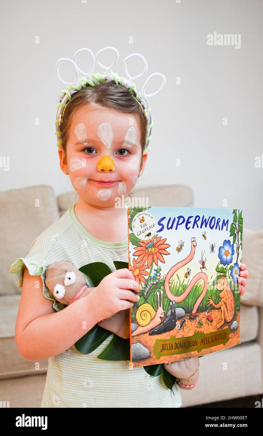 Brighton UK 3rd March 2022 - Five year old Isabella from Brighton dressed in a home made costume as characters from 'Superworm' on the 25th anniversary of World Book Day in the UK today . World Book Day encourages children around the world to enjoy books and shared reading : Credit Simon Dack / Alamy Live News Stock Photo