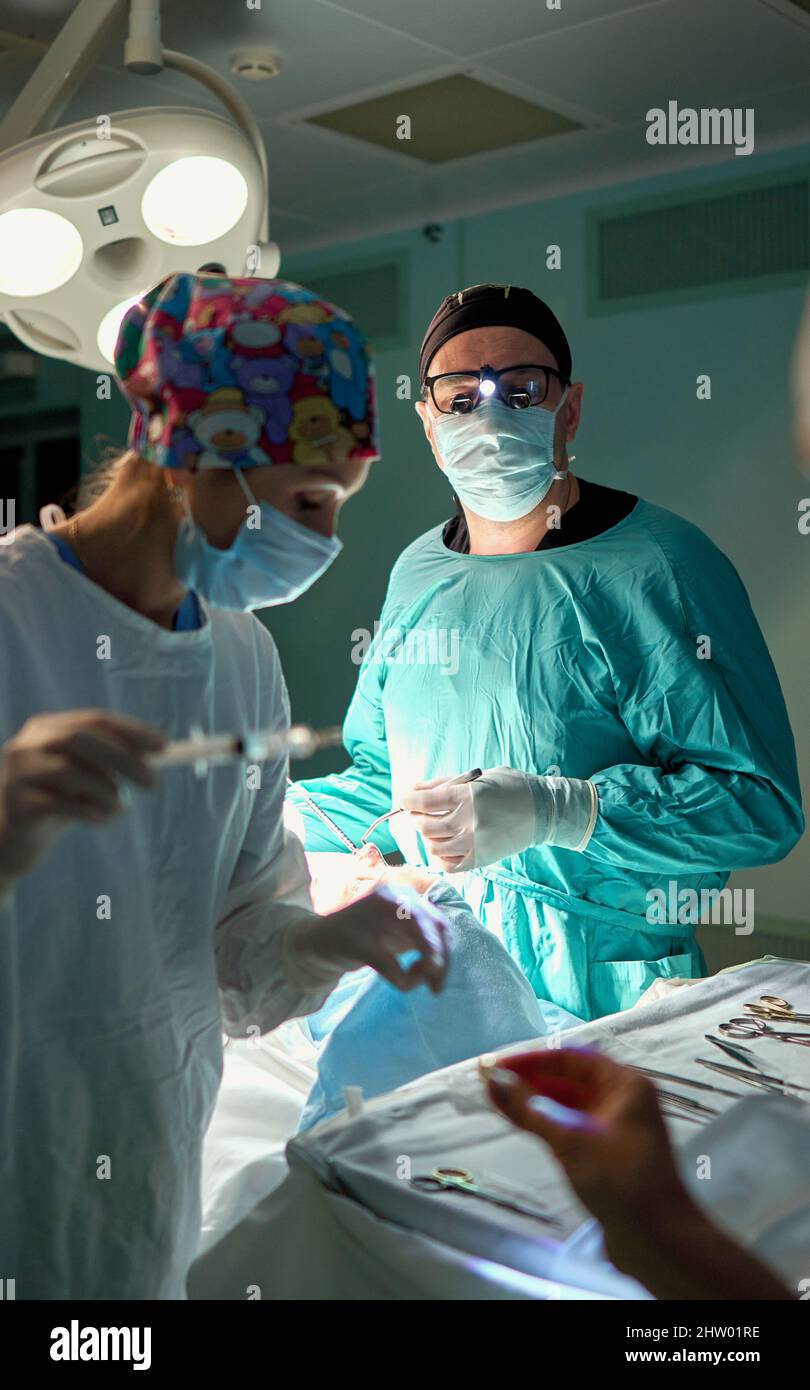 Operating Room Assistant I In the hospital operating room. An international team of professional ...
