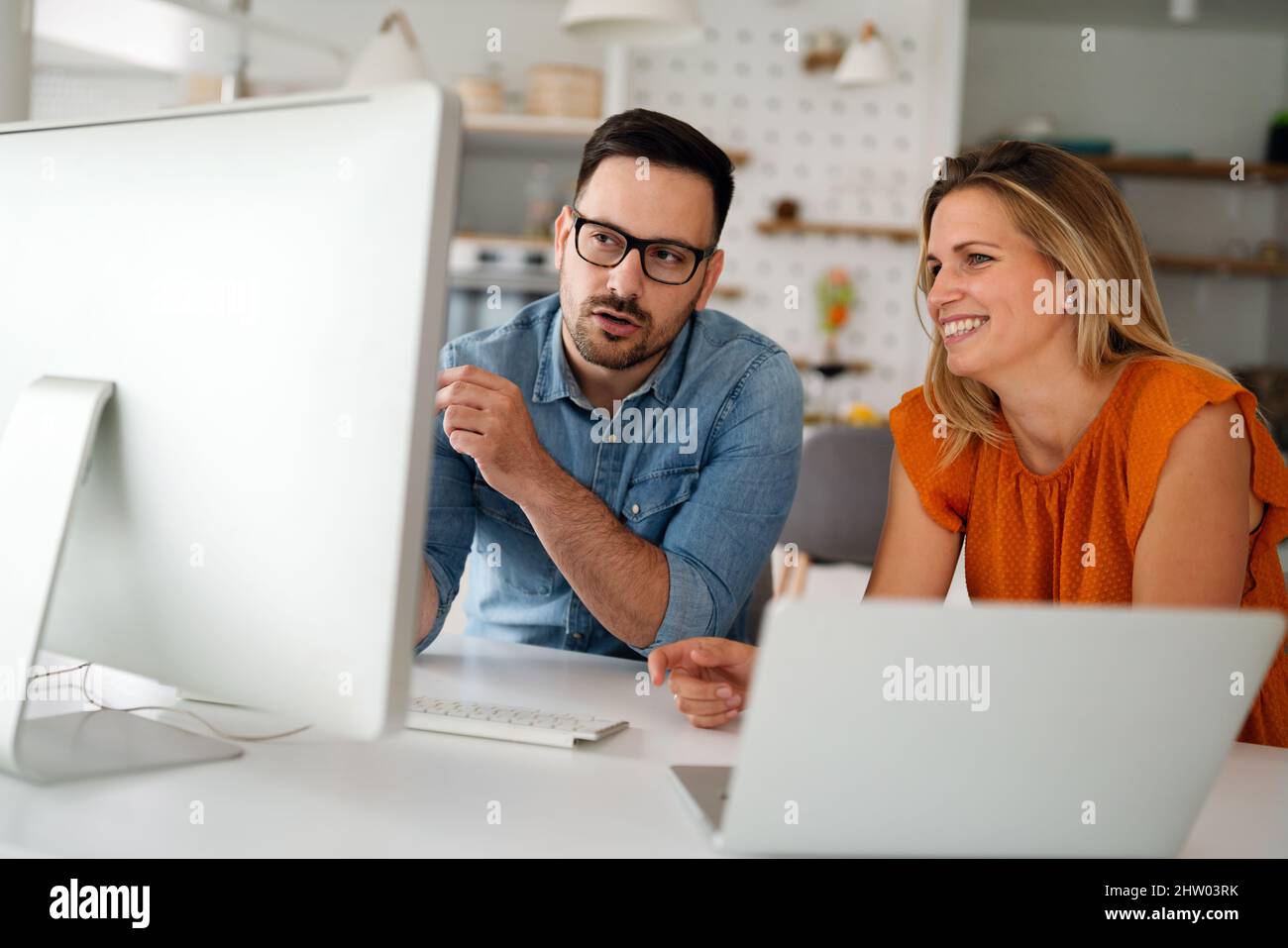 Programmers cooperating at IT company developing apps Stock Photo