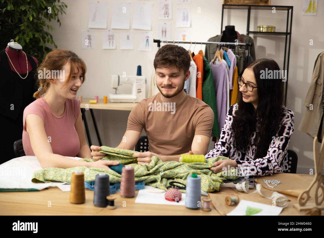 The work of fashion designer and tailors in the shop. Fashion designers ...