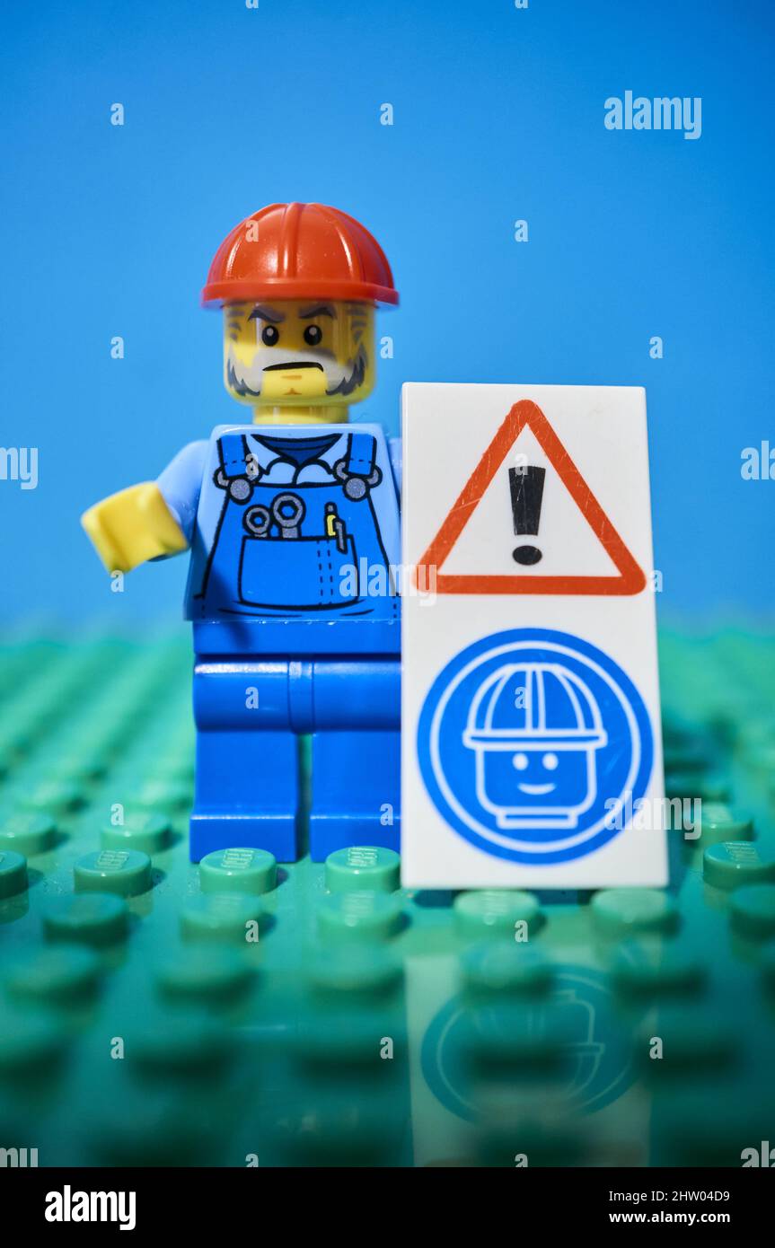 Brand construction worker toy figurine with red helmet holding a