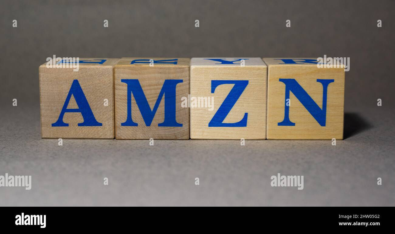 January 19, 2022. New York, USA. Stock ticker symbol from Amazon.com, Inc. AMZN, laid out from wooden cubes, on a gray background. Stock Photo