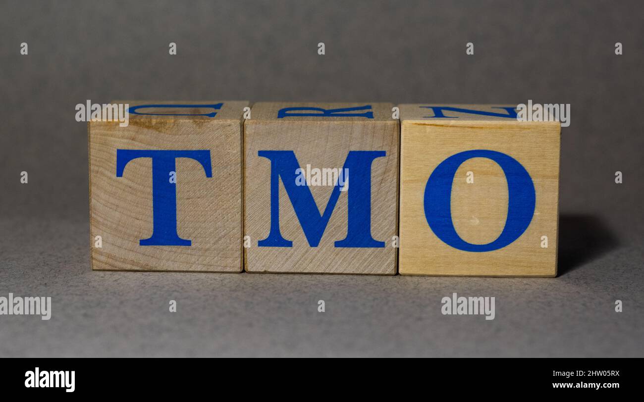 January 19, 2022. New York, USA. The stock Ticker symbol of Thermo Fisher Scientific TMO, made of wooden cubes, on a gray background. Stock Photo