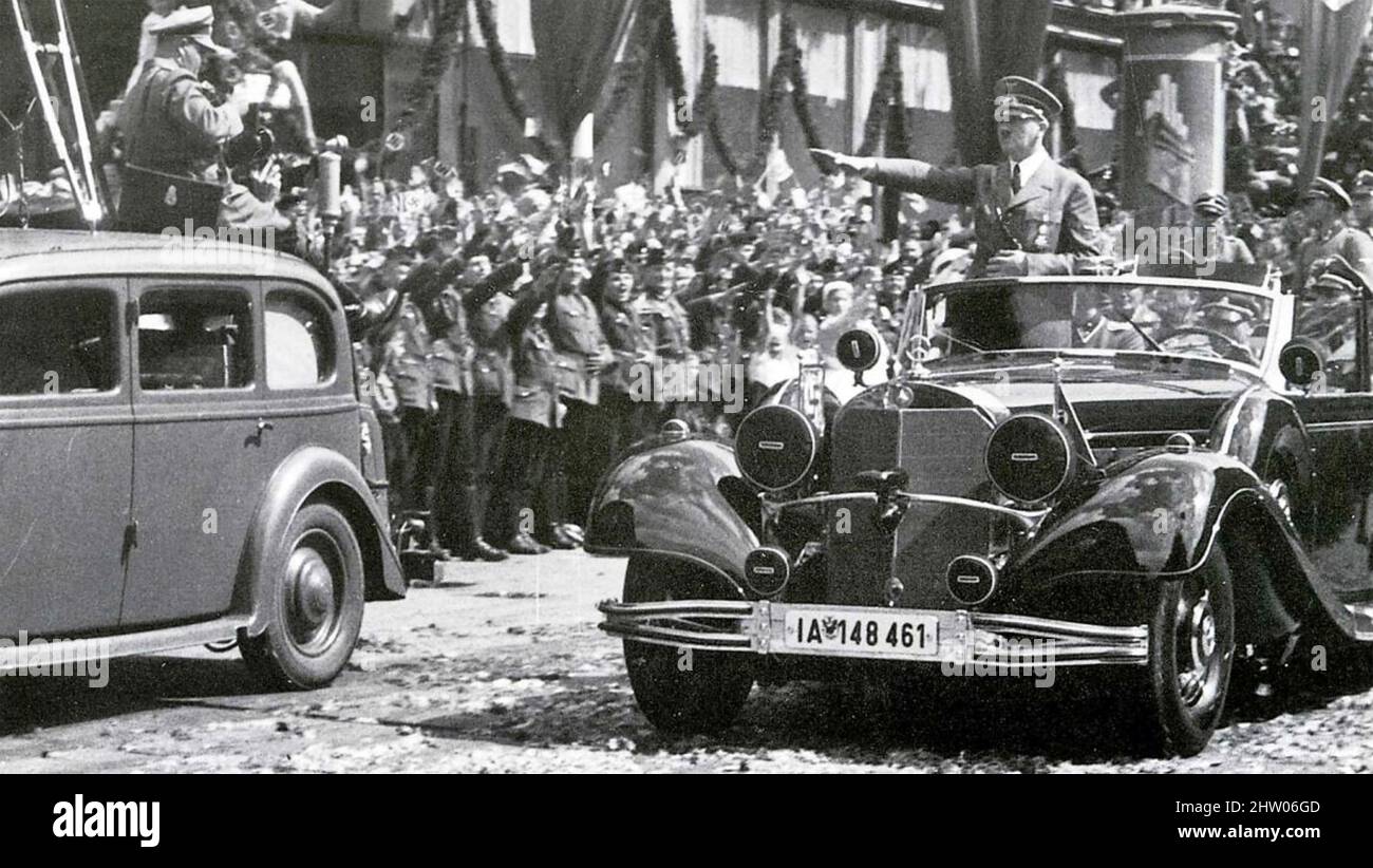 ADOLF HITLER (1889-1945) giving the Nazi salute from his Mercedes-Benz in Berlin in July 1940 after his visit to German-occupied Paris. Note camerman at left. Stock Photo