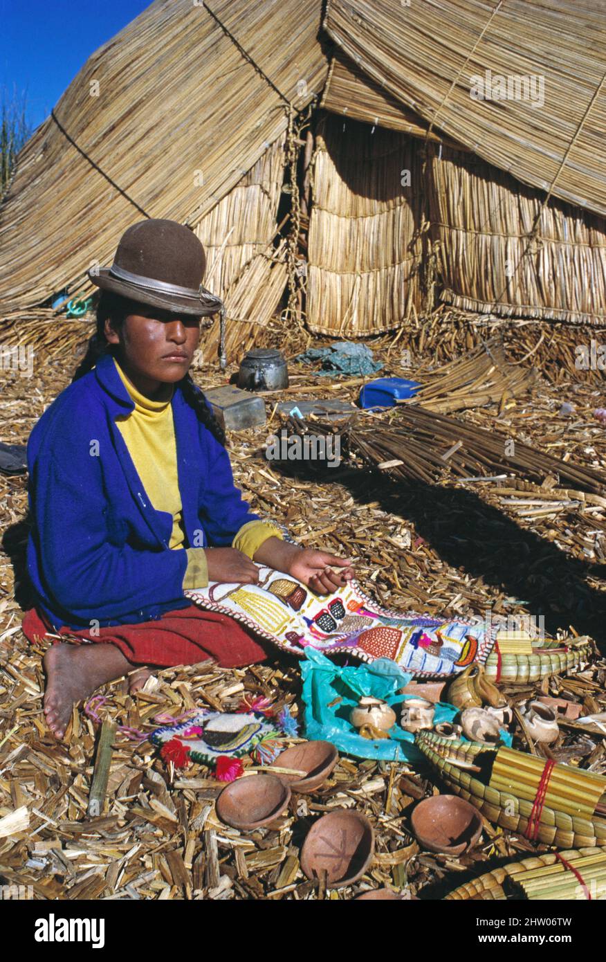 Peru. Lake Titicaca region. Floating island village. Uru woman trader. Stock Photo