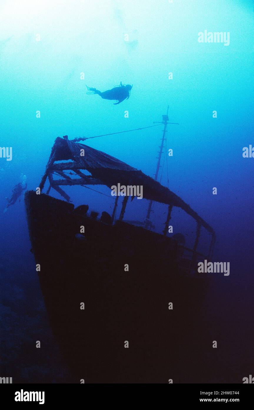 Micronesia. Sunken ship sitting upright on ocean floor with scuba divers. Stock Photo