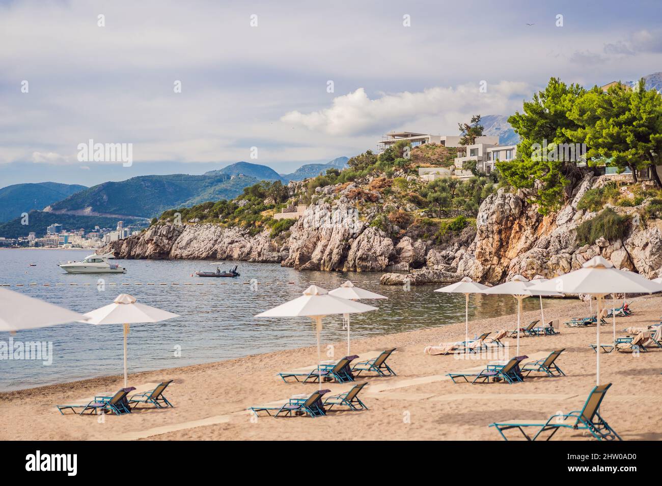 Picturesque summer view of Adriatic sea coast in Budva Riviera near Przno village. Cozy beach and buildings on the rock. Location: Przno village Stock Photo