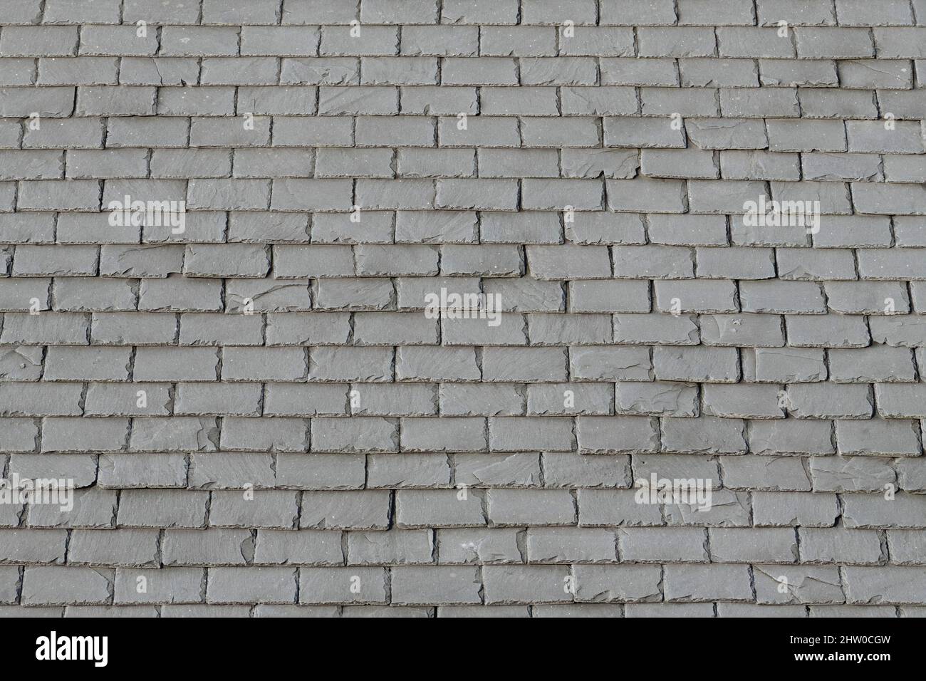 Rows of Grey Slate Roofing Tiles on a Frosty Roof Stock Photo
