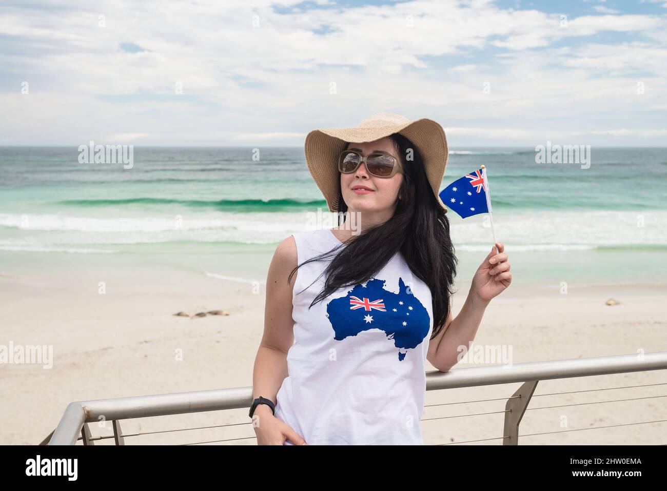 Young woman celebrating Autralia Day  while holding Australian Flag at Kangaroo Island, South Australia Stock Photo