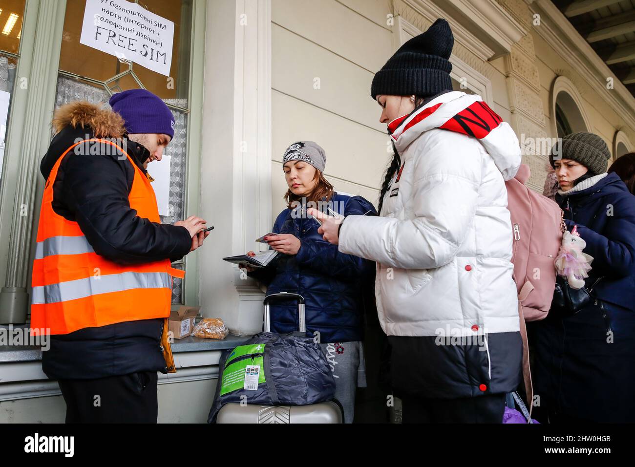 Ukrainians receive free sim cards after arriving at the railway station in Przemysl, Poland