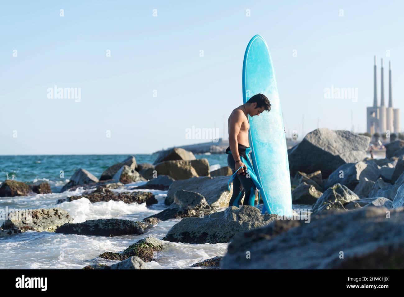 Hispanic man holding surf board hi-res stock photography and images - Alamy