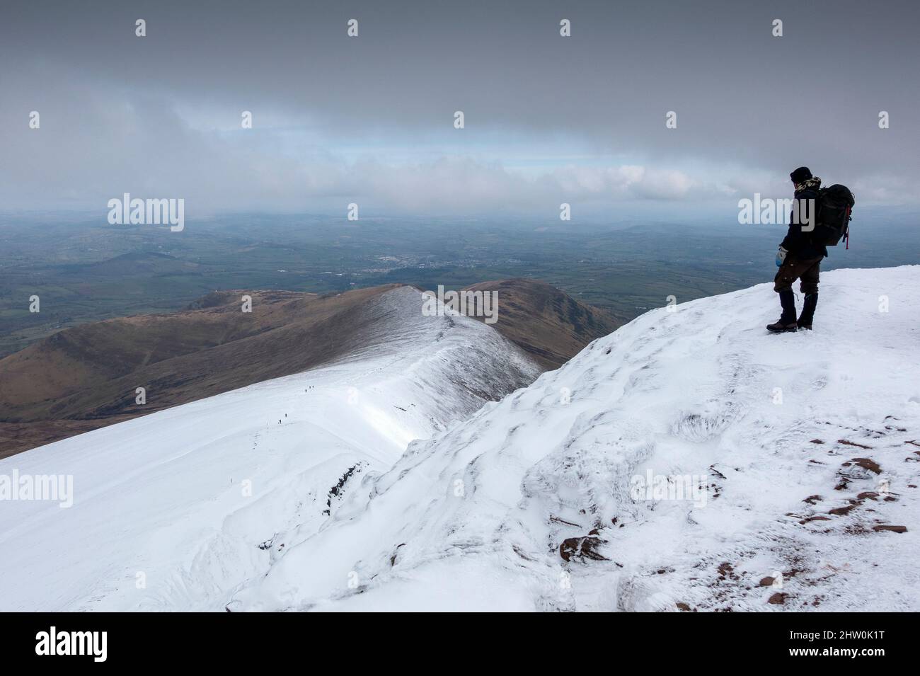 Hiker walking the snow covered Pen Y Fan in the Brecon Beacons National Park, Wales, UK Stock Photo
