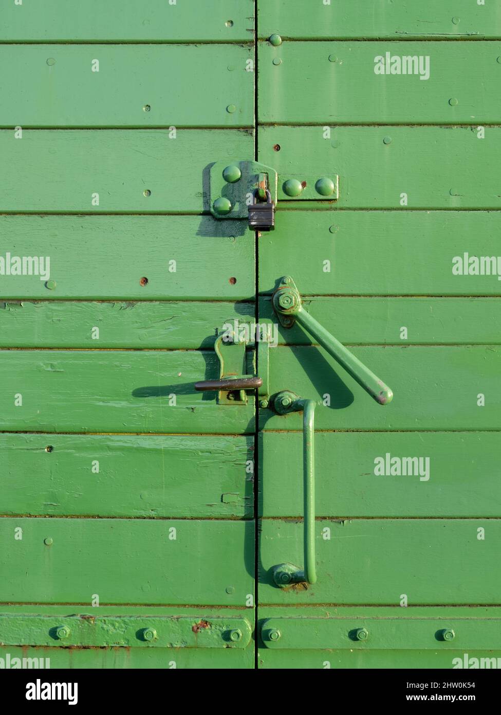 Green vintage train carriage door closure, lock. Stock Photo