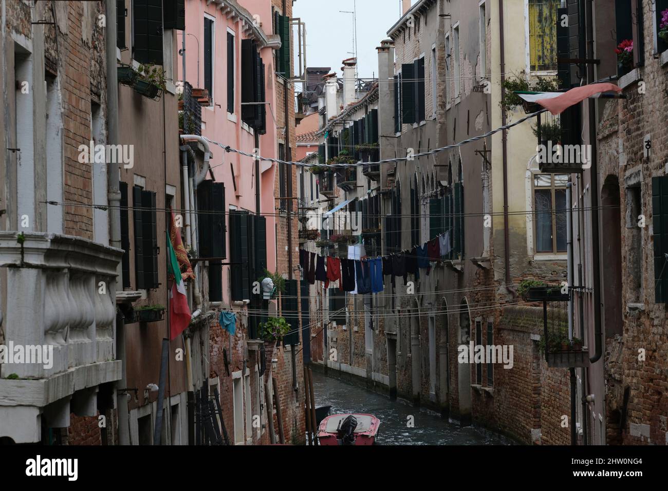 washing hanging out to dry across a canal in venice Stock Photo