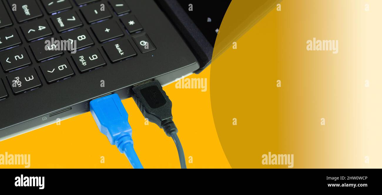 Connecting computers and laptops to the using USB cables. Yellow background with place