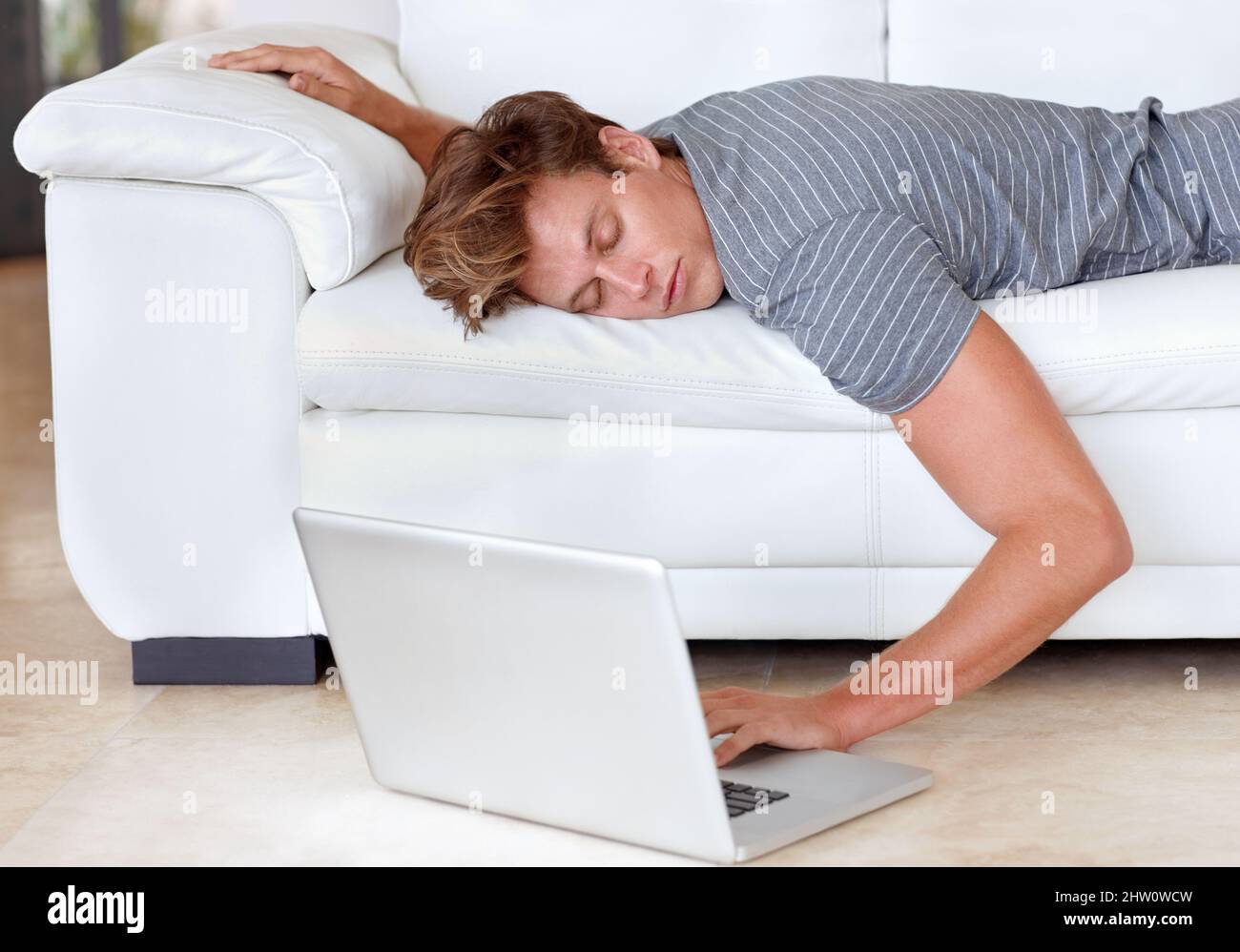 Highspeed connection for couch potatoes. A young man lying on his