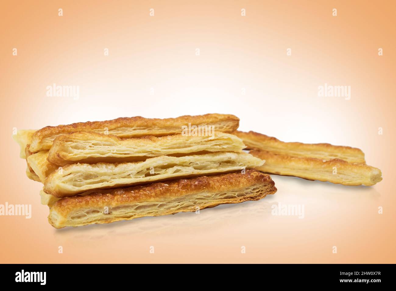 Delicious and sweet puff pastry sticks with cinnamon. Background with
