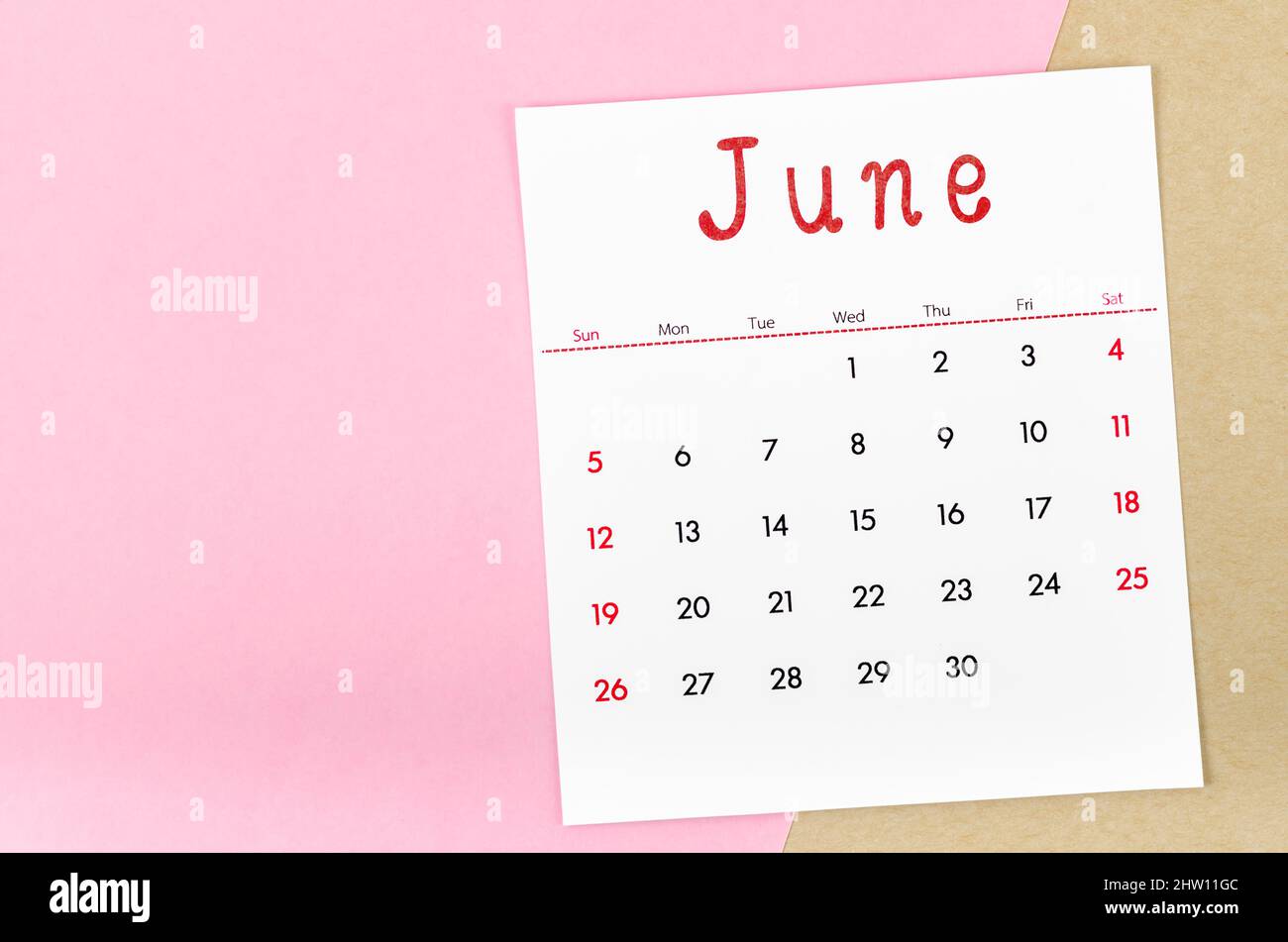 The June 2022 calendar on pink background with empty space. Stock Photo