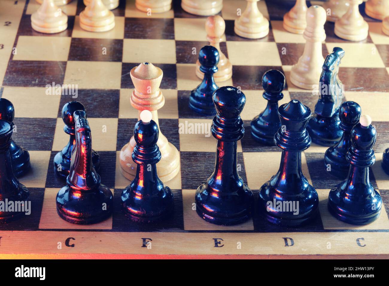 In chess, the white queen checked the black king Stock Photo - Alamy