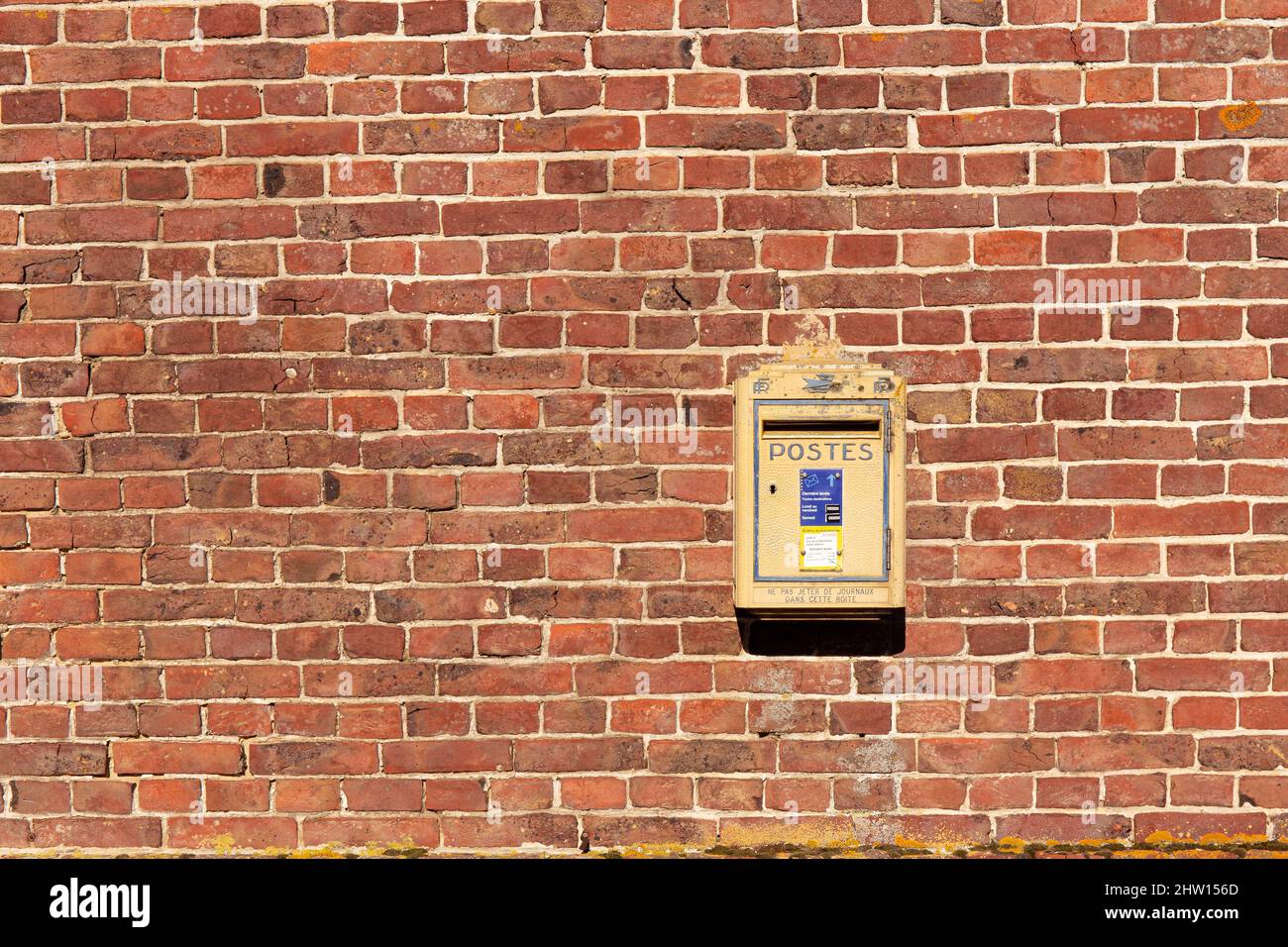 Official french mail boxes on a brick wall Stock Photo