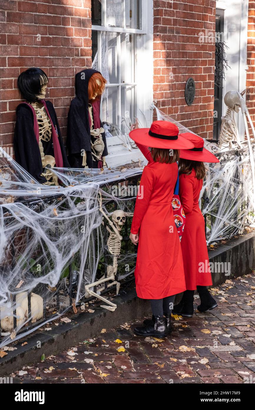 Halloween Decorations, Old Town, Alexandria, Virginia, USA. Little Girls Regarding Skeletons. Stock Photo