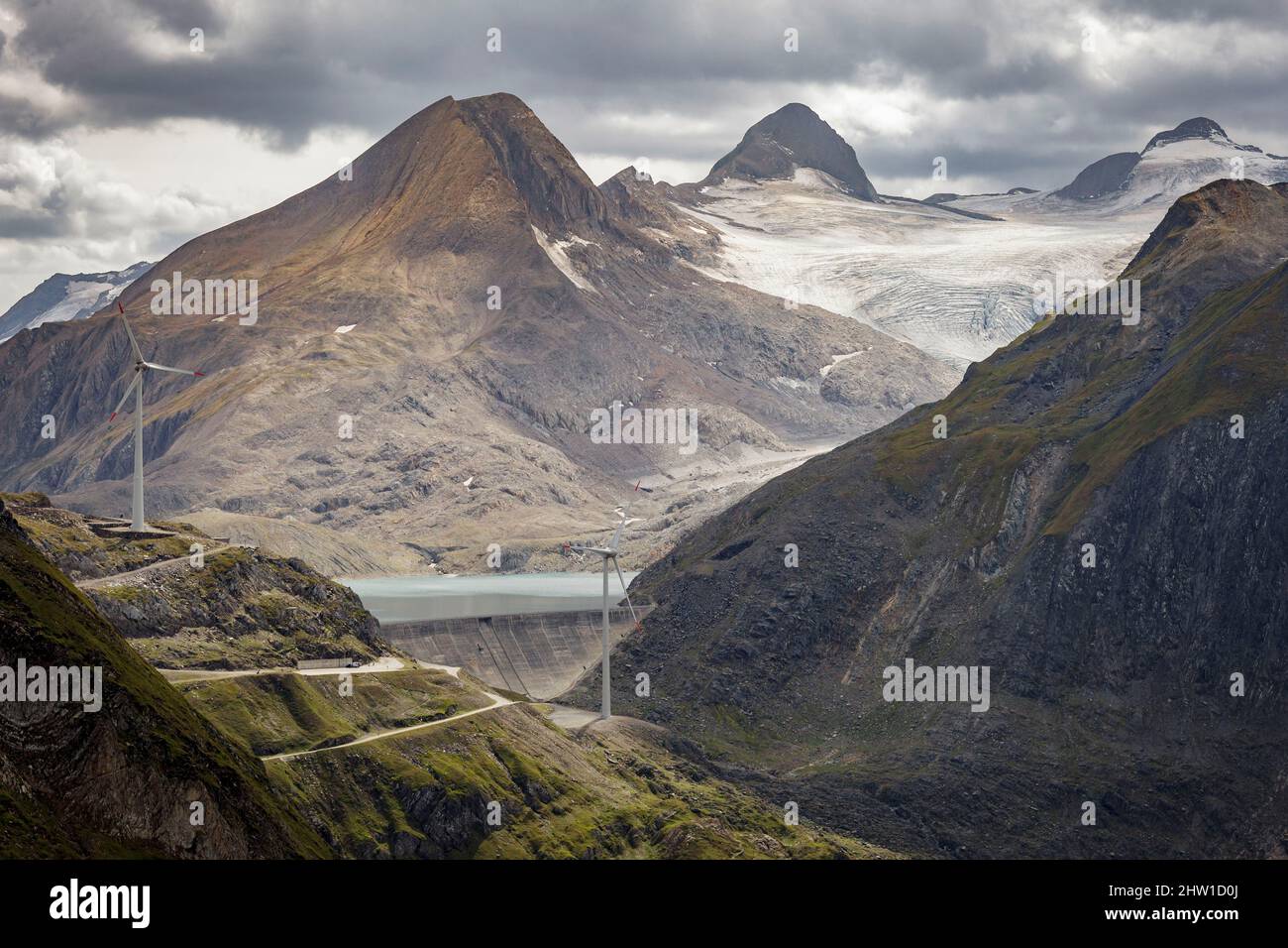 Switzerland, canton of Ticino, Ulrichen, Nufenen pass, Gries dam, two wind turbines in their mountain environment, site of the highest wind farm in Europe, 2500 meters above sea level, view of Arbola Peak (Ofenhorn, 3235m), in the background, located on the Italy-Switzerland border Stock Photo