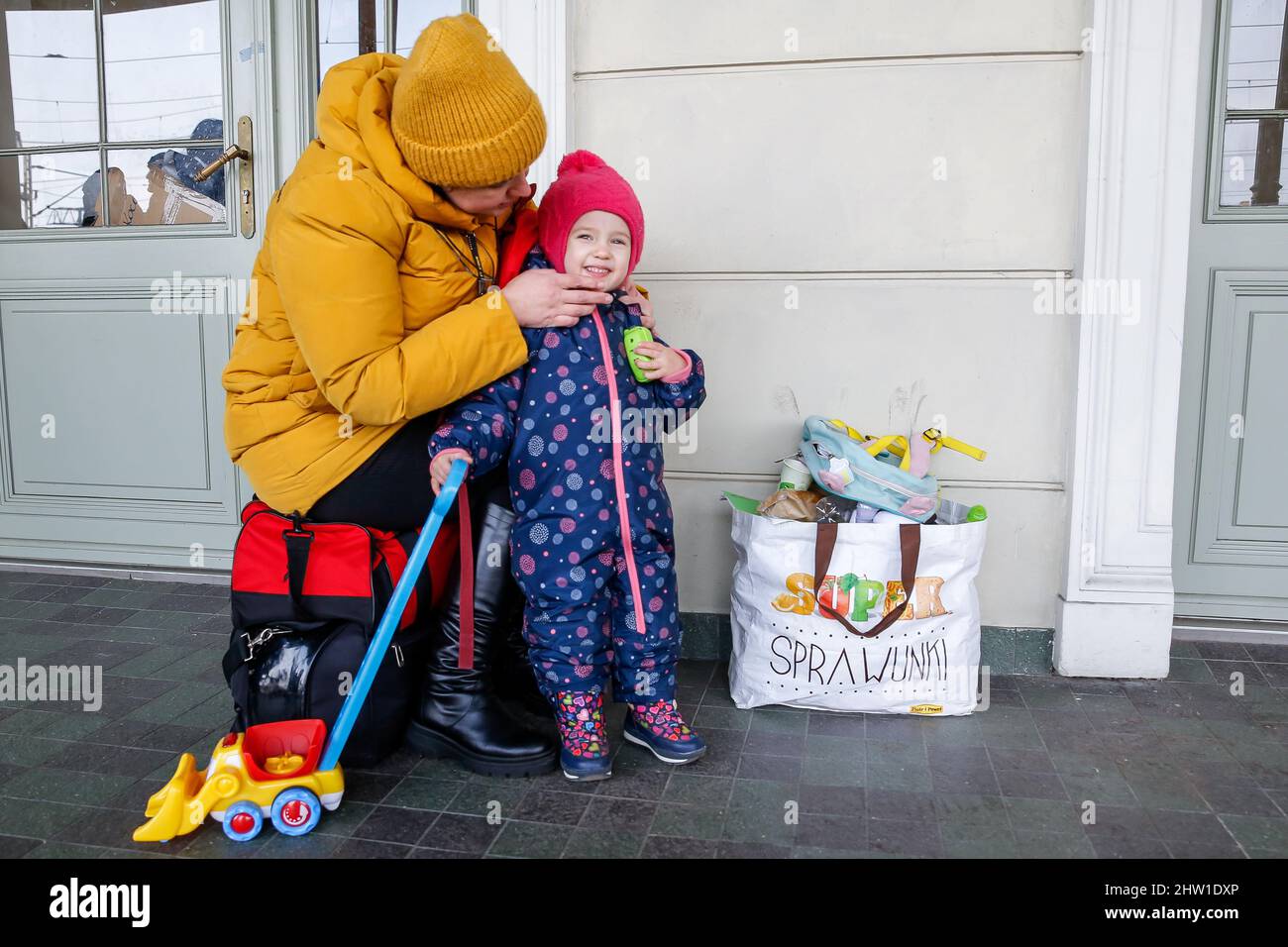 Przemysl, Poland. 03rd Mar, 2022. A Ukrainian family arrives at the railway station in PrzemyslAs the Russian Federation army crossed Ukrainian borders the conflict between Ukraine and Russian is expected to force up to 4 million Ukrainians to flee. Many of the refugees will seek asylum in Poland, already more than 300 thousand people fled Ukraine for Poland. Most escapees arrived to border towns like Przemysl and are relocated to inner cities. Credit: SOPA Images Limited/Alamy Live News Stock Photo