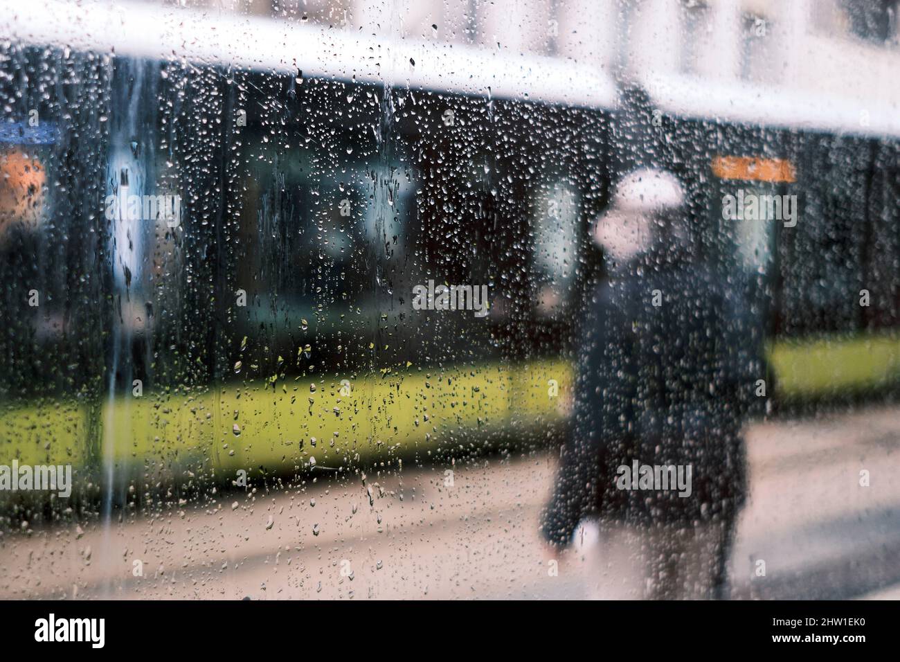 France, Finistere, Brest, man at the streetcar stop on rue de Siam in rainy weather Stock Photo