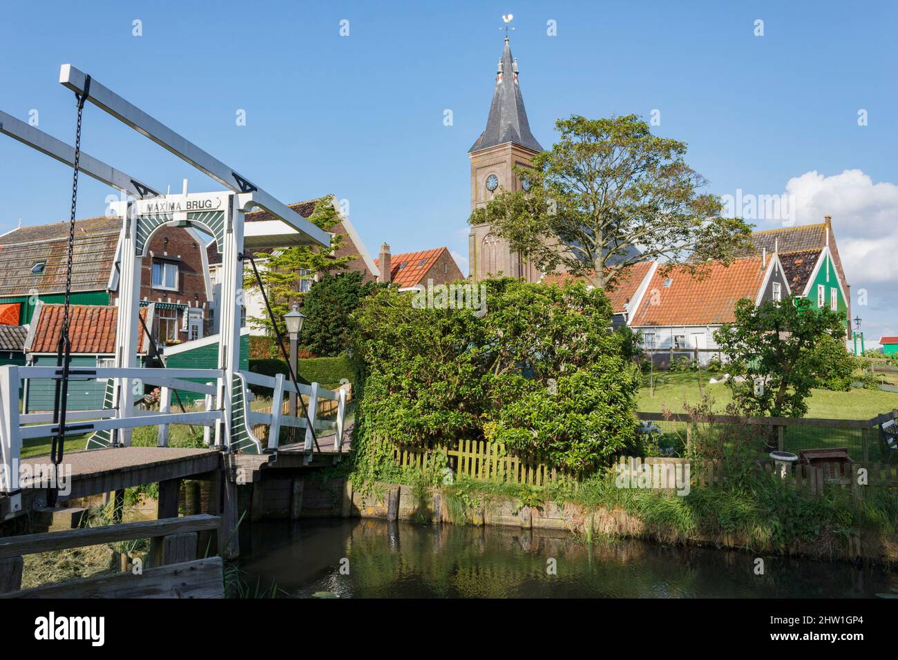 Netherlands, North Holland, Marken, pedestrian bridge, church and typical painted wooden houses Stock Photo