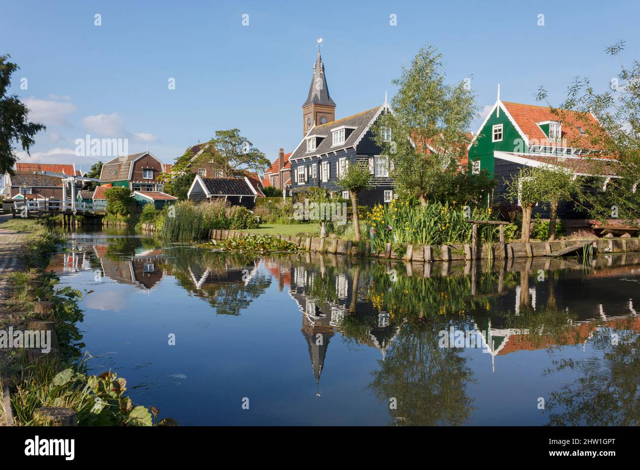 Netherlands, North Holland, Marken, church and typical wooden houses painted in green and black Stock Photo