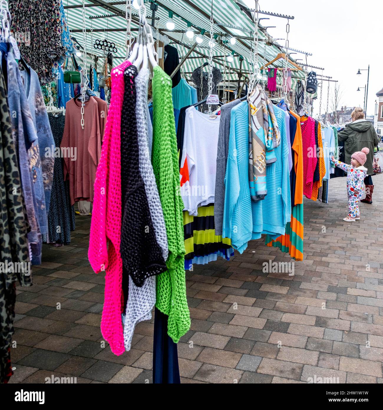 Epsom Surrey London UK, March 03 2022, Little Girl Looking At Fashion Clothing On A Market Stall Stock Photo