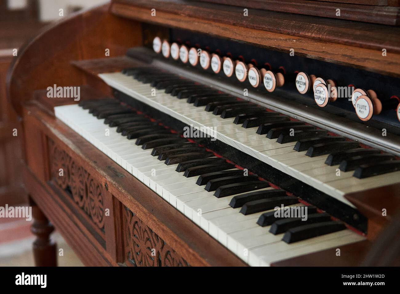 Old wooden harmonium inside a church Stock Photo