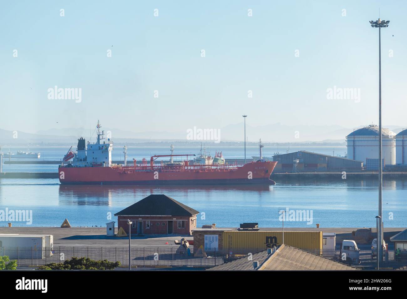 Cape Town, South Africa, 26th February - 2022: Ship approaches harbour with fuel tanks in background. Stock Photo