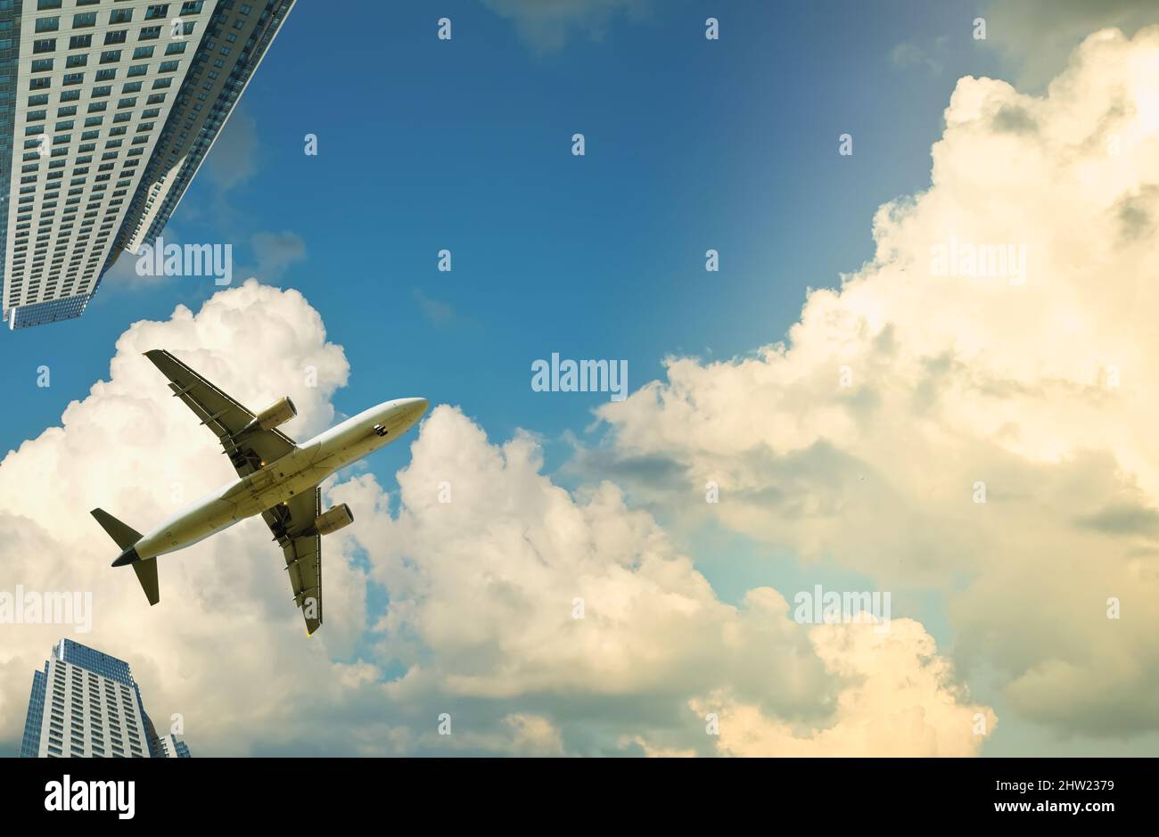 plane in sky on skyscrapers background Stock Photo - Alamy